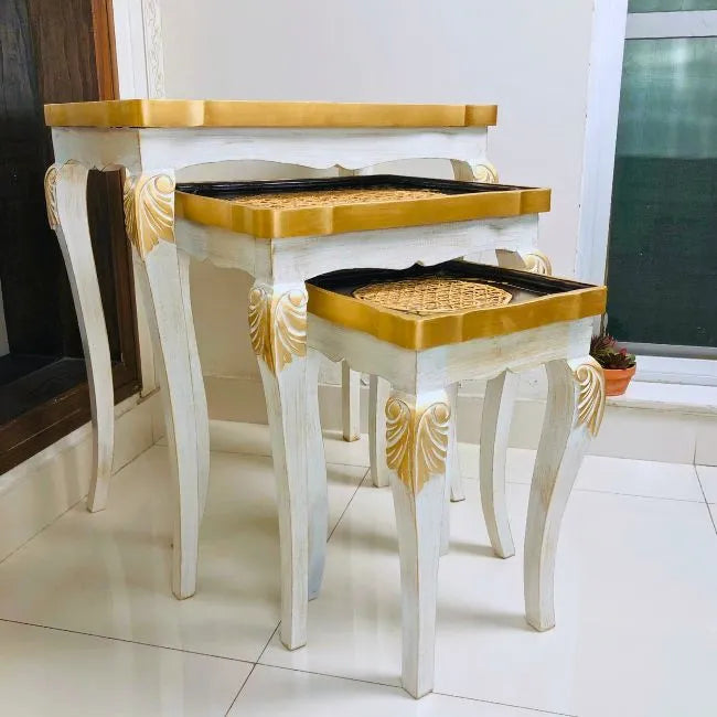 Side view of black and gold nesting tables with intricate cane detailing and durable Kikar wood construction