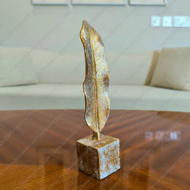 Detailed Golden Feather resin sculpture with antique gold finish for elegant home decor styling.