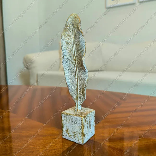 Detailed Golden Feather resin sculpture with distressed ivory finish for elegant home decor styling.