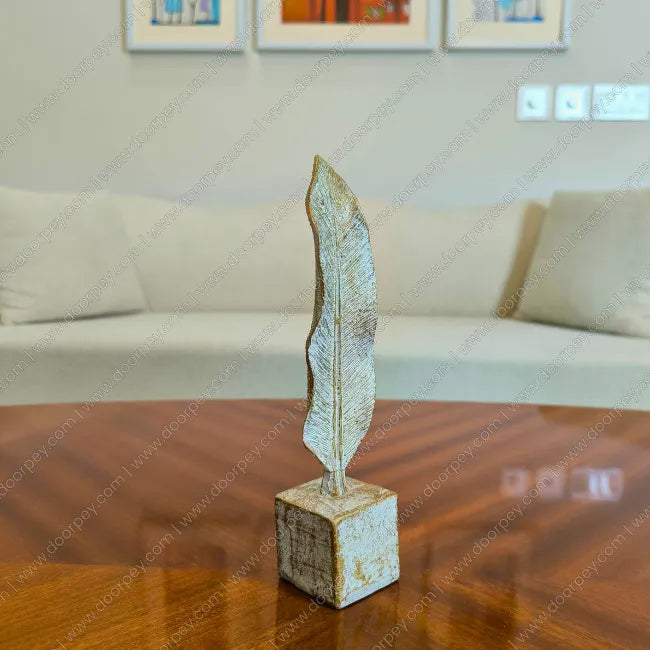 Detailed Golden Feather resin sculpture with distressed ivory finish for elegant home decor styling.