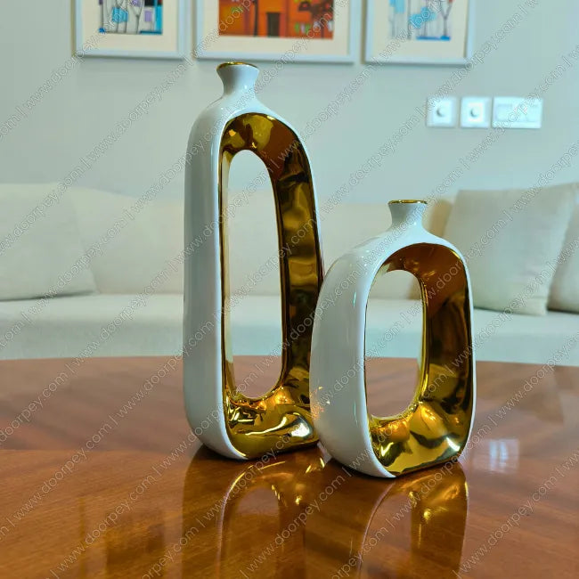 Detailed Golden Halo ceramic vase set with white and gold finish for elegant home decor styling.