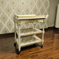 Front view of hand-painted wooden serving trolley with floral designs and durable construction.