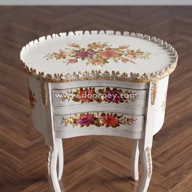 Wooden end table with floral patterns on a wooden floor