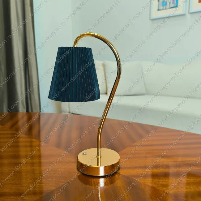 Elegant Lumière Curve Cordless Table Lamp with a radiant gold finish and unique sculptural form for modern home lighting and decor accents