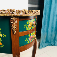 Close up image of a wooden side table in brown and green with gold accents