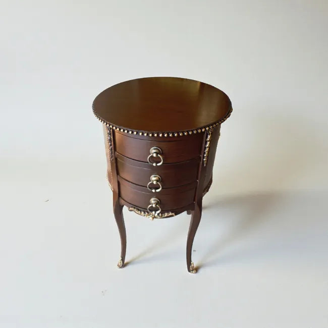 Royal Bastion end table with refined drawers and ornamental accents