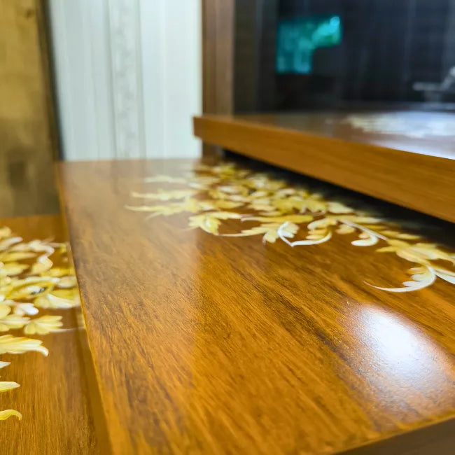 Close-up of Rustic Harmony nesting tables, highlighting the fine hand-painted gold floral artwork on a smooth wood finish