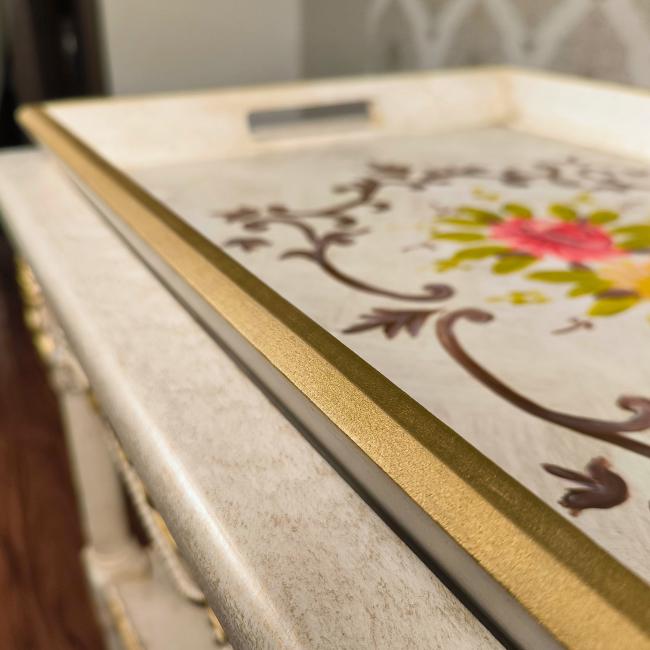 Close-up of hand-painted floral designs on the sturdy Garden Elegance serving cart.