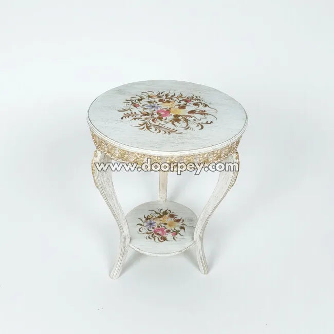 Decorative round wooden table with floral patterns on a white background