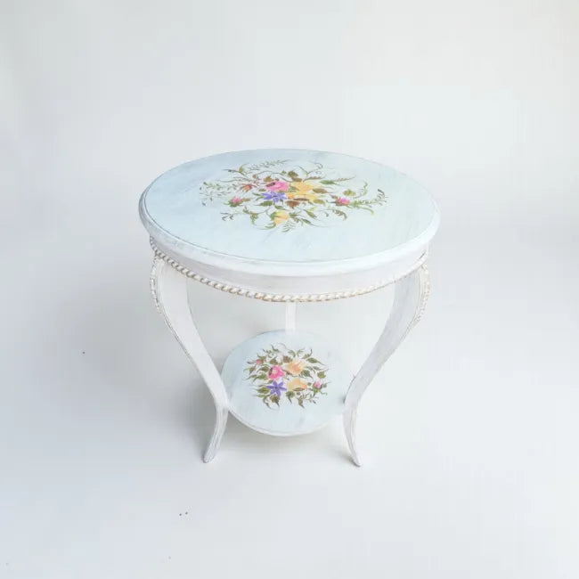 White hand painted round wooden side table featuring floral artwork and elegant curved legs crafted from kikar wood