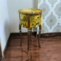 Decorative accent table with intricate design on a wooden floor.