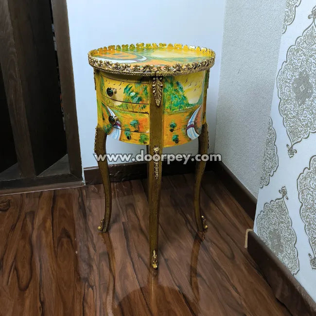 Hand painted side accent table with artistic design on a wooden floor.