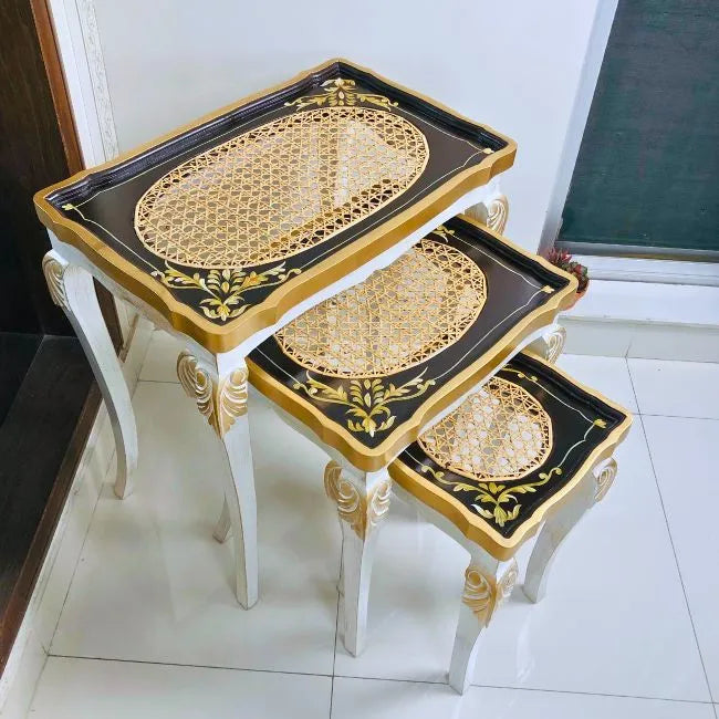 Black and gold cane nesting tables enhancing a modern living space with timeless elegance and functional design
