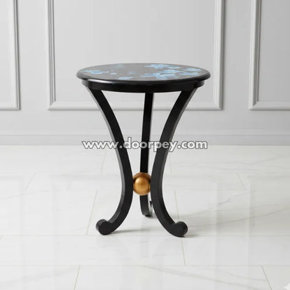Black round wooden side table featuring hand painted blue floral artwork and elegant curved legs
