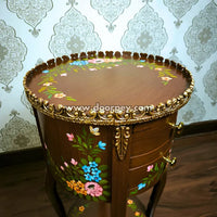 Close up of round hand painted wooden table.