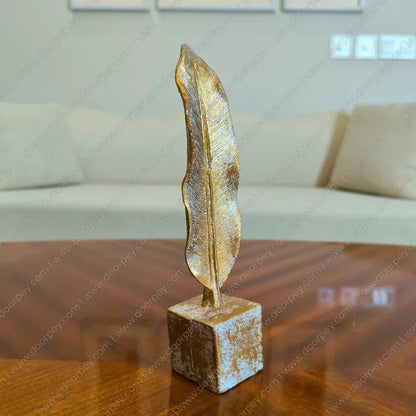 Detailed Golden Feather resin sculpture with antique gold finish for elegant home decor styling.