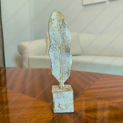 Elegant Golden Feather resin sculpture with distressed ivory finish for sophisticated home decor styling