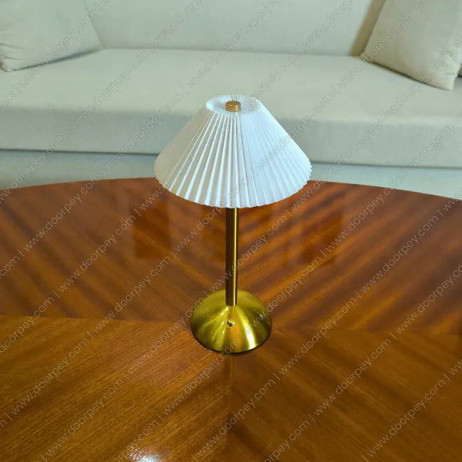 Minimalist Lumière cordless table lamp with a sleek portable design for modern home lighting and decor accents.