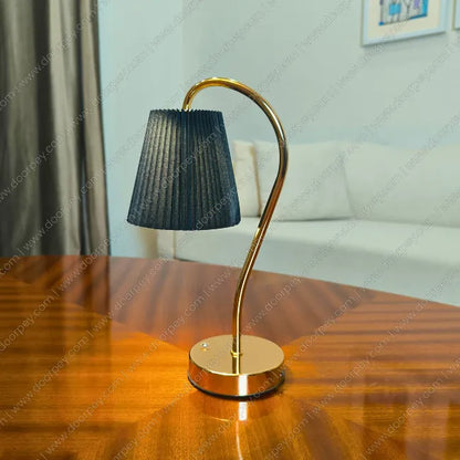 Lumière Curve Cordless Table Lamp with a radiant gold finish and unique sculptural form for modern home decor styling