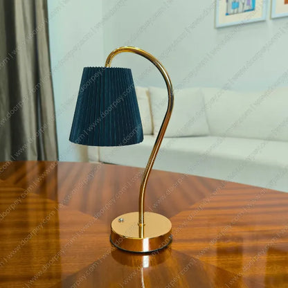 Elegant Lumière Curve Cordless Table Lamp with a radiant gold finish and unique sculptural form for modern home lighting and decor accents