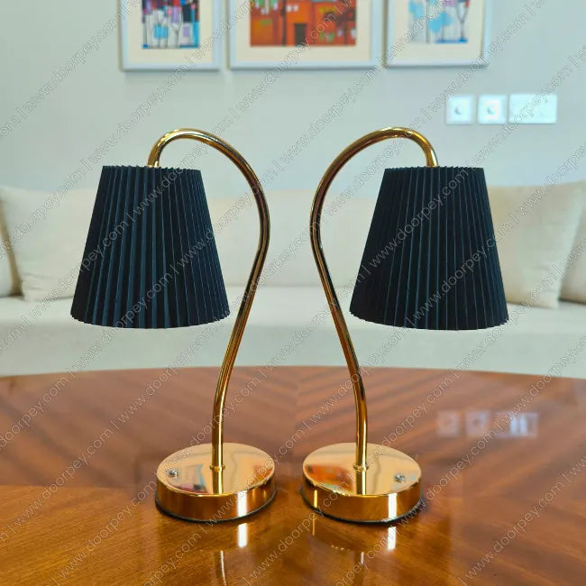 Elegant Lumière Curve Cordless Table Lamp with a radiant gold finish and unique sculptural form for artistic home decor and ambient lighting.