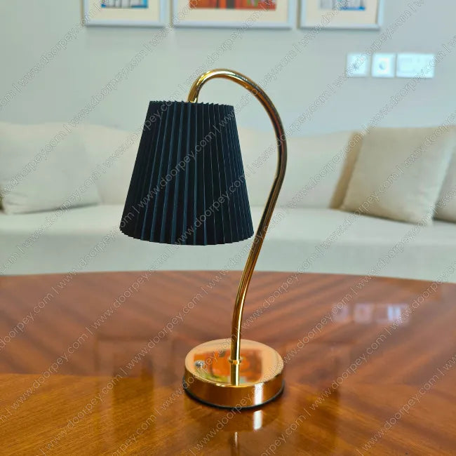 Modern Lumière Curve cordless table lamp with a radiant gold finish and unique sculptural form for elegant bedside or console table ambient lighting.