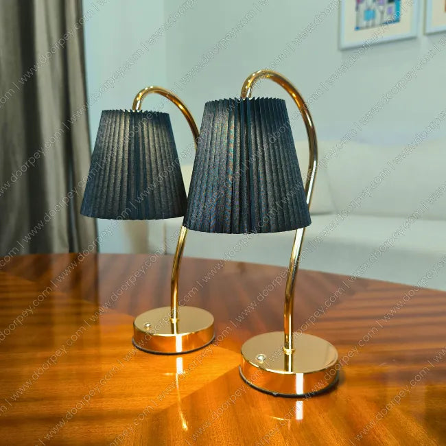 Detailed Lumière Curve Cordless Table Lamp with a radiant gold finish and unique sculptural form for elegant home decor styling.