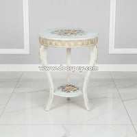Decorative side table with floral patterns on a white floor and gray wall background