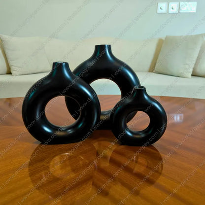 Detailed Noir Loop Decorative Vase Set with a black resin finish for modern minimalism home decor styling on console tables and shelves.