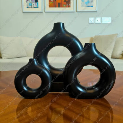 Detailed Noir Loop Decorative Vase Set with a black resin finish, a sophisticated 3-piece donut vase collection for modern home decor styling.
