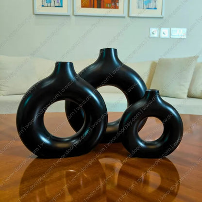 Elegant Noir Loop Decorative Vase Set with a black resin finish, a sophisticated 3-piece donut vase collection for modern home decor styling on console tables.