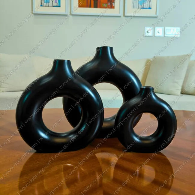 Elegant Noir Loop Decorative Vase Set with a black resin finish, a sophisticated 3-piece donut vase collection for modern home decor styling on console tables.