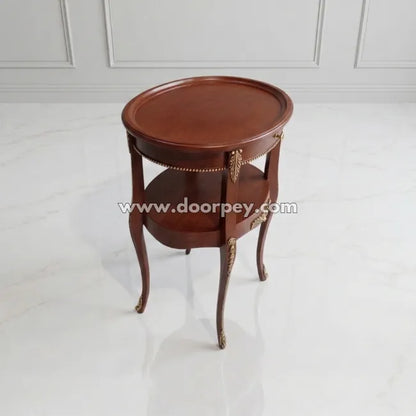 Round antique wooden side table with classic brown finish and decorative gold accents