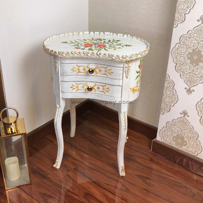Front view of a white wooden end table with hand painted patterns