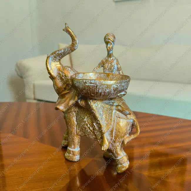 Detailed Savannah Empress Elephant Sculpture with an antique gold finish, a sophisticated resin figurine for luxury home decor styling.