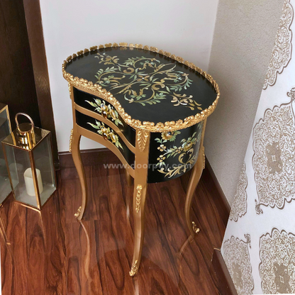 Side profile of a black and golden wooden side table with hand painted patterns.