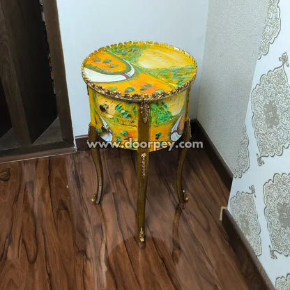 hand painted side table with artistic design on a wooden floor.