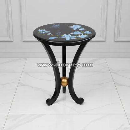 Twilight Blossom round hand painted accent table with blue floral design on black wooden top made from kikar wood