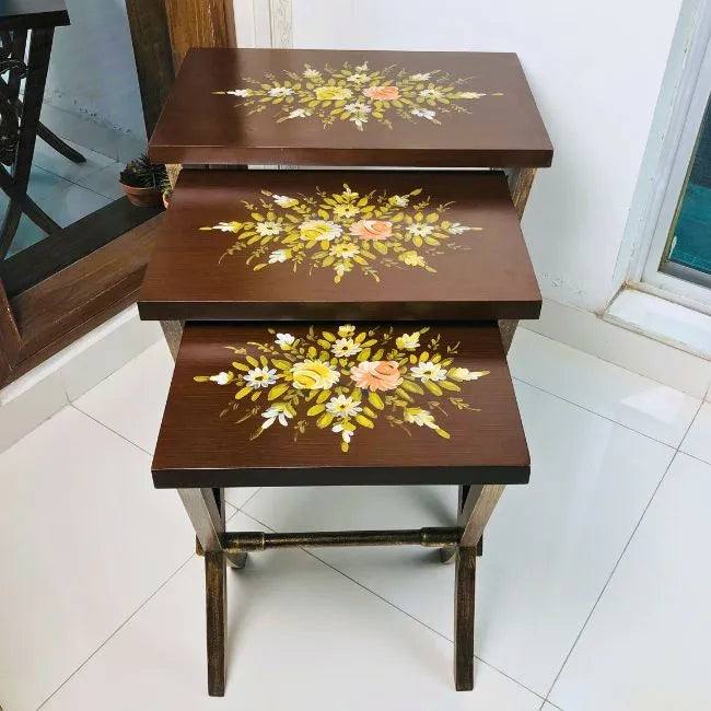 Side view of Woodland Wonders wooden nesting tables showcasing intricate floral artwork and durable Kikar wood construction.