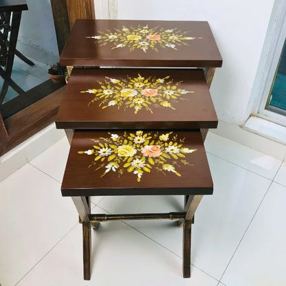 Side view of Woodland Wonders wooden nesting tables showcasing intricate floral artwork and durable Kikar wood construction.